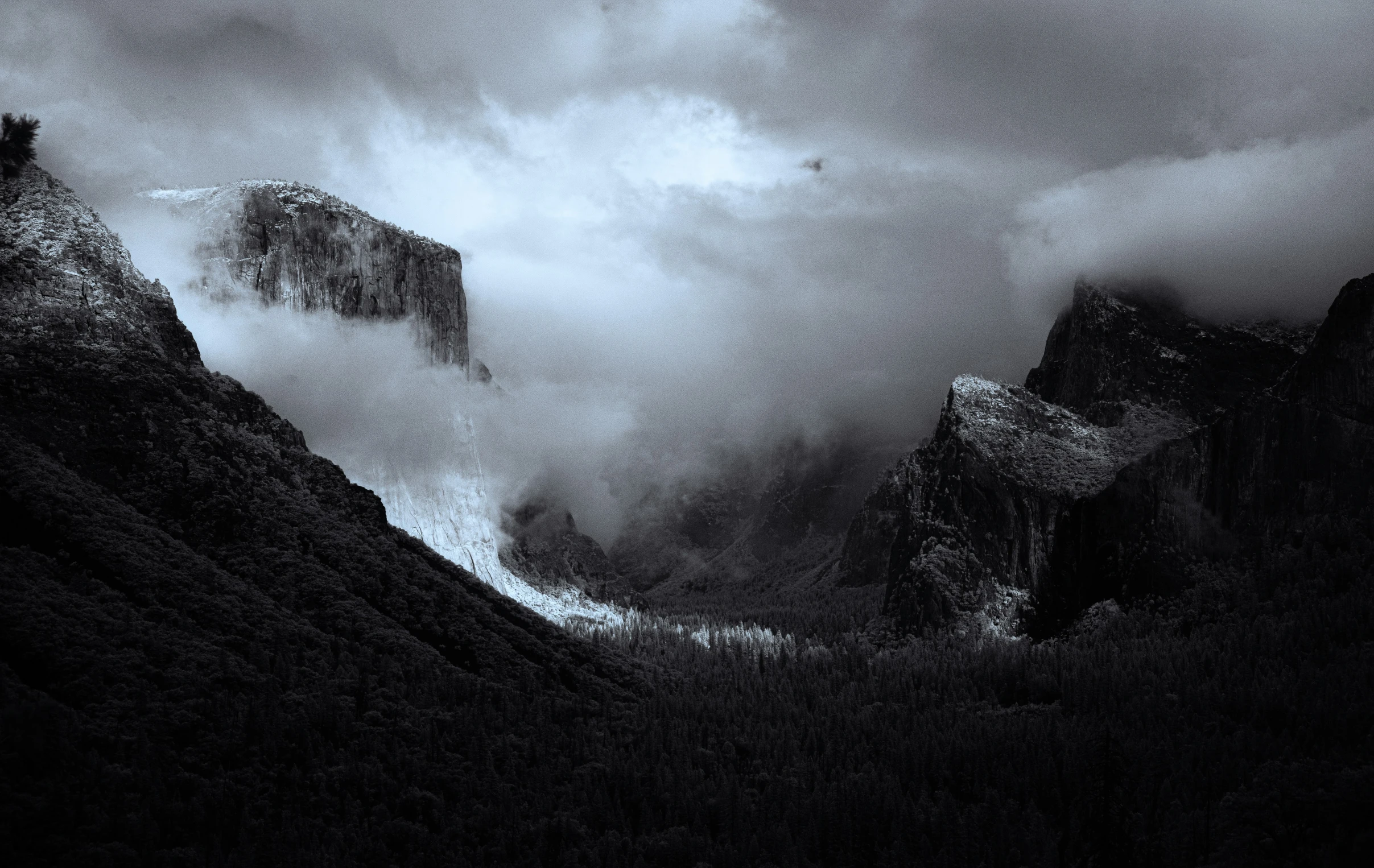 a mountain range under a dark cloudy sky