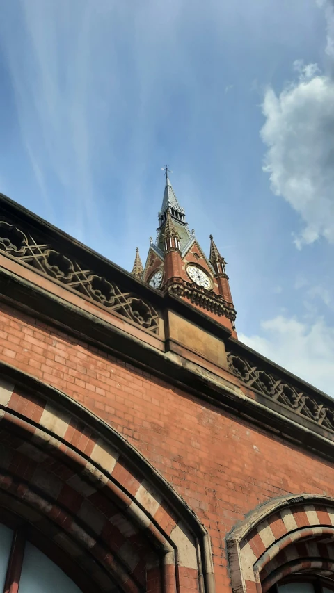 an old red brick building with a clock tower