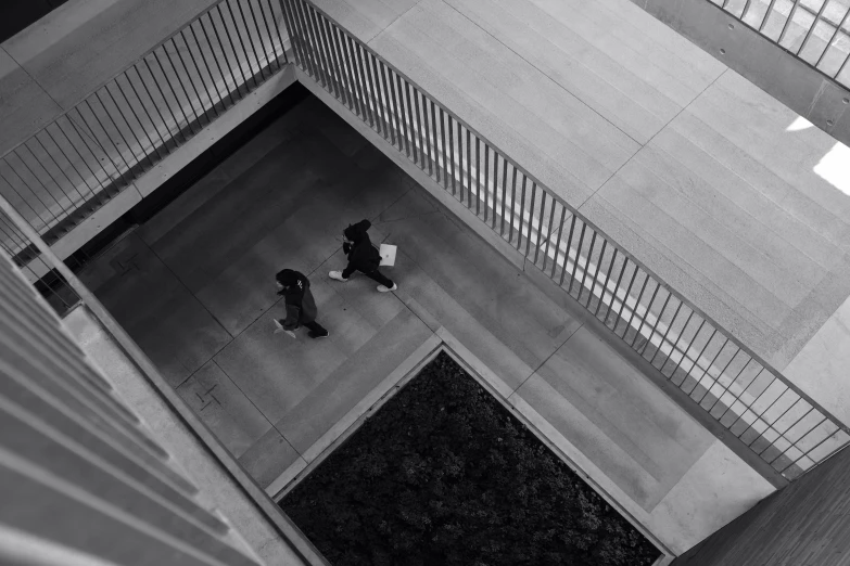 two people walking up stairs near an office building