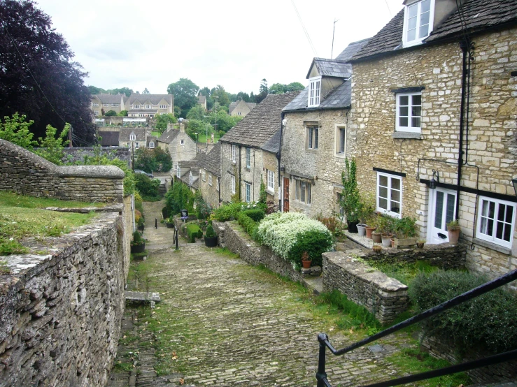 several stone building with white windows on the left side of them