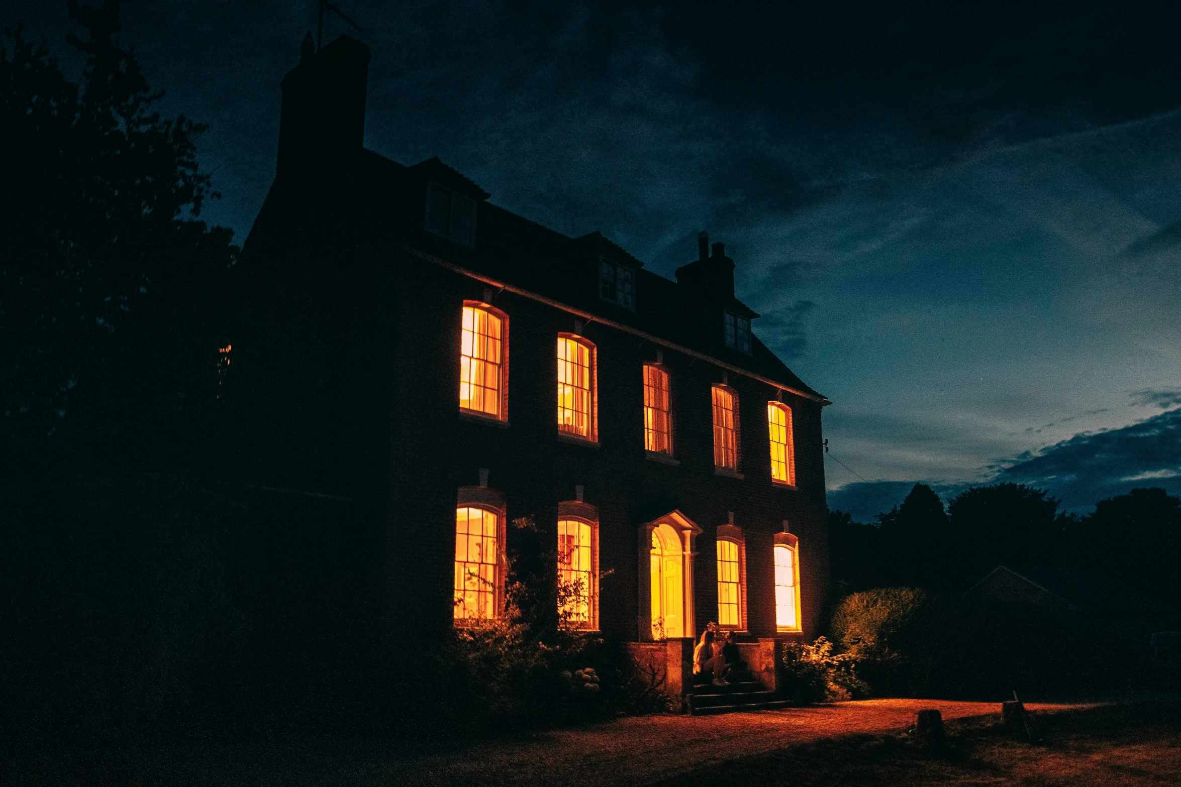 a lighted building in the dark at night