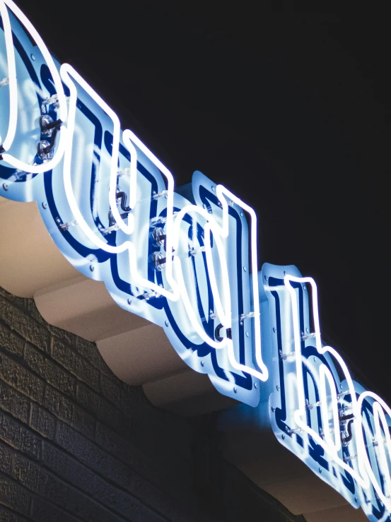 a lighted sign is on the roof of a building