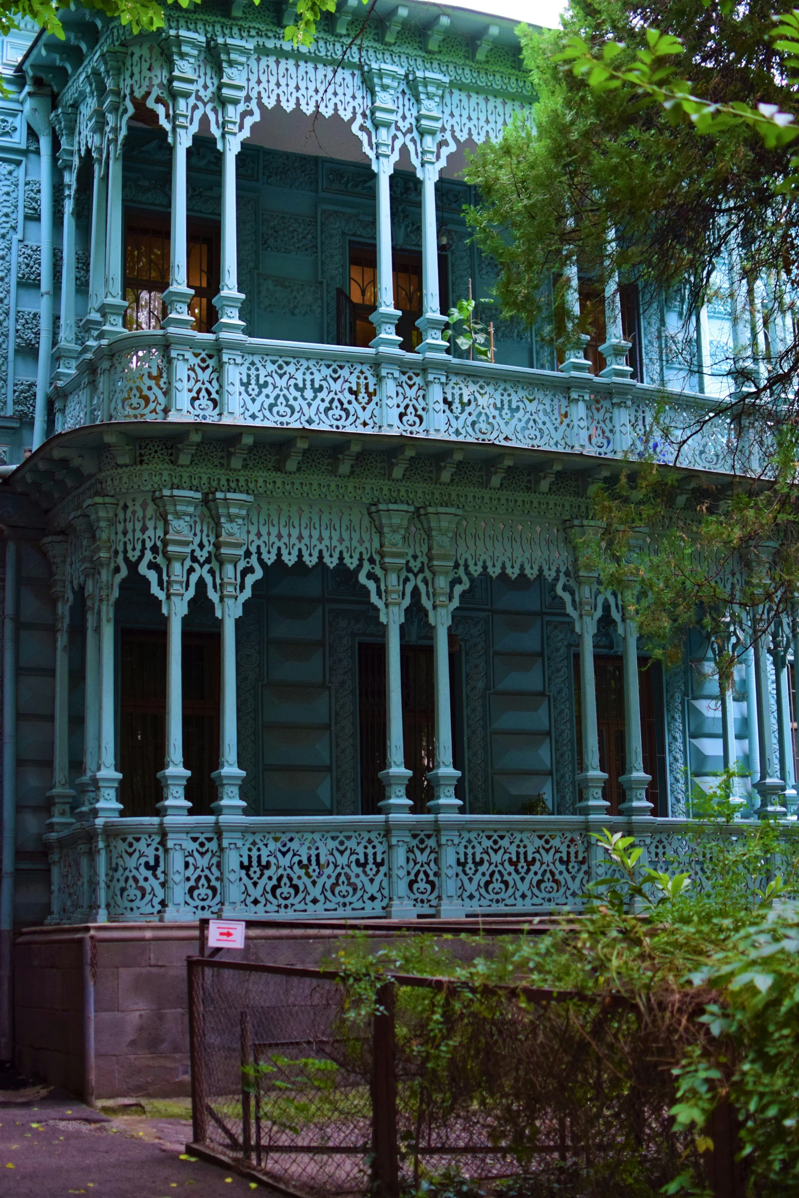 a blue building with many stories and designs on it