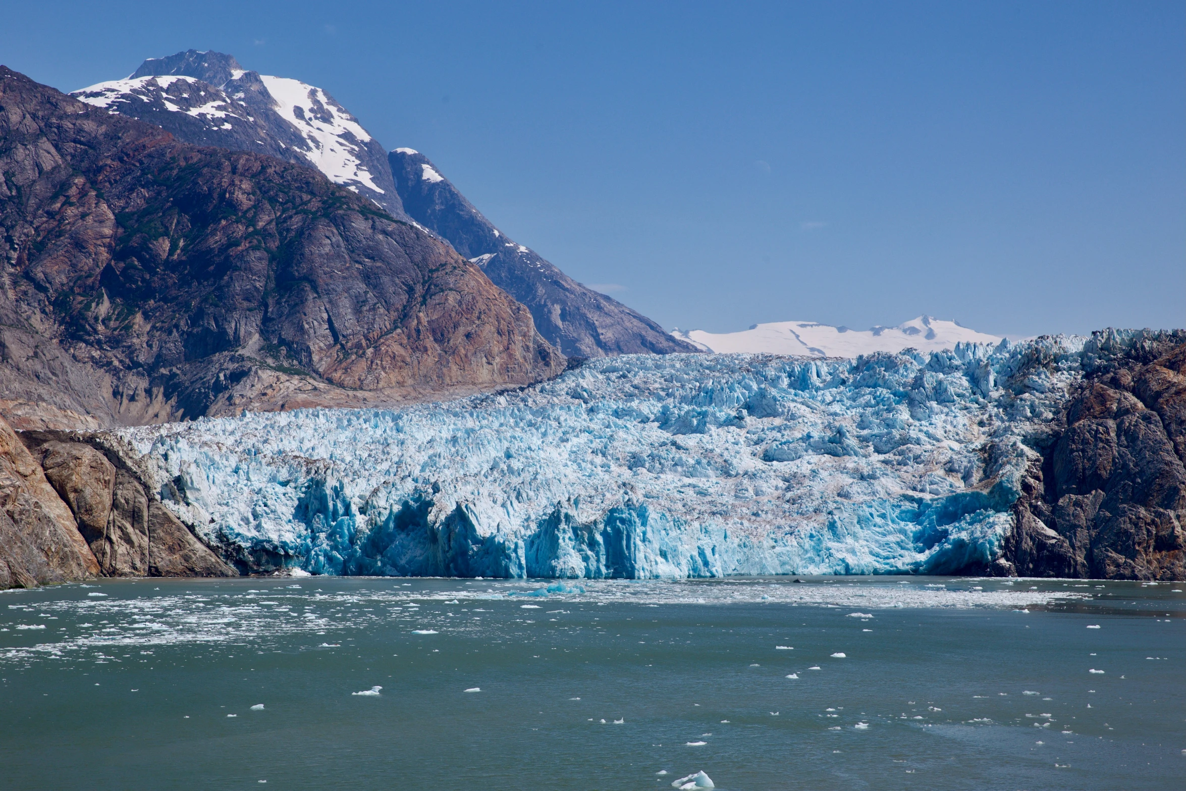 a view of a large glacier from a small boat