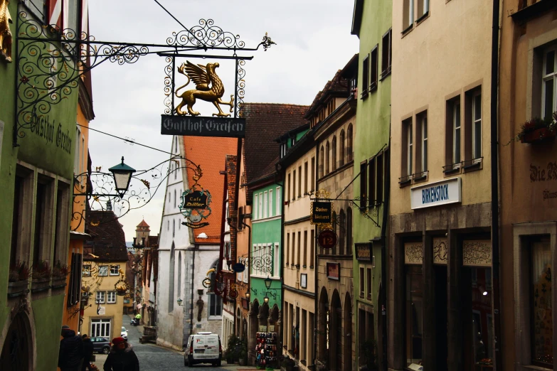 a small city street with cars and pedestrians