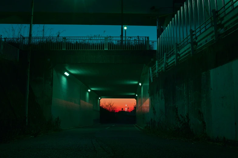 the view from the inside of a tunnel at night