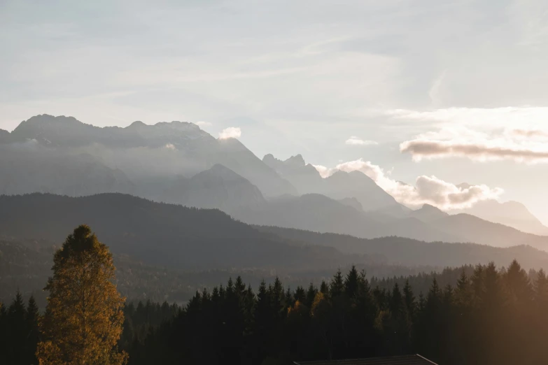 a house sitting next to a mountain in the distance