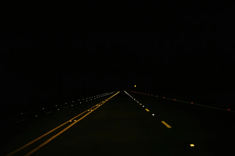 the empty highway is lit up at night