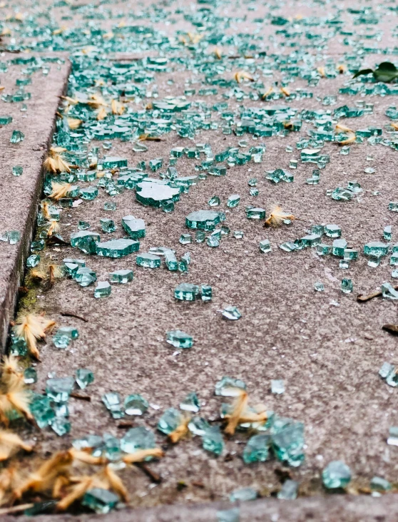 broken glass sits in the middle of a sidewalk