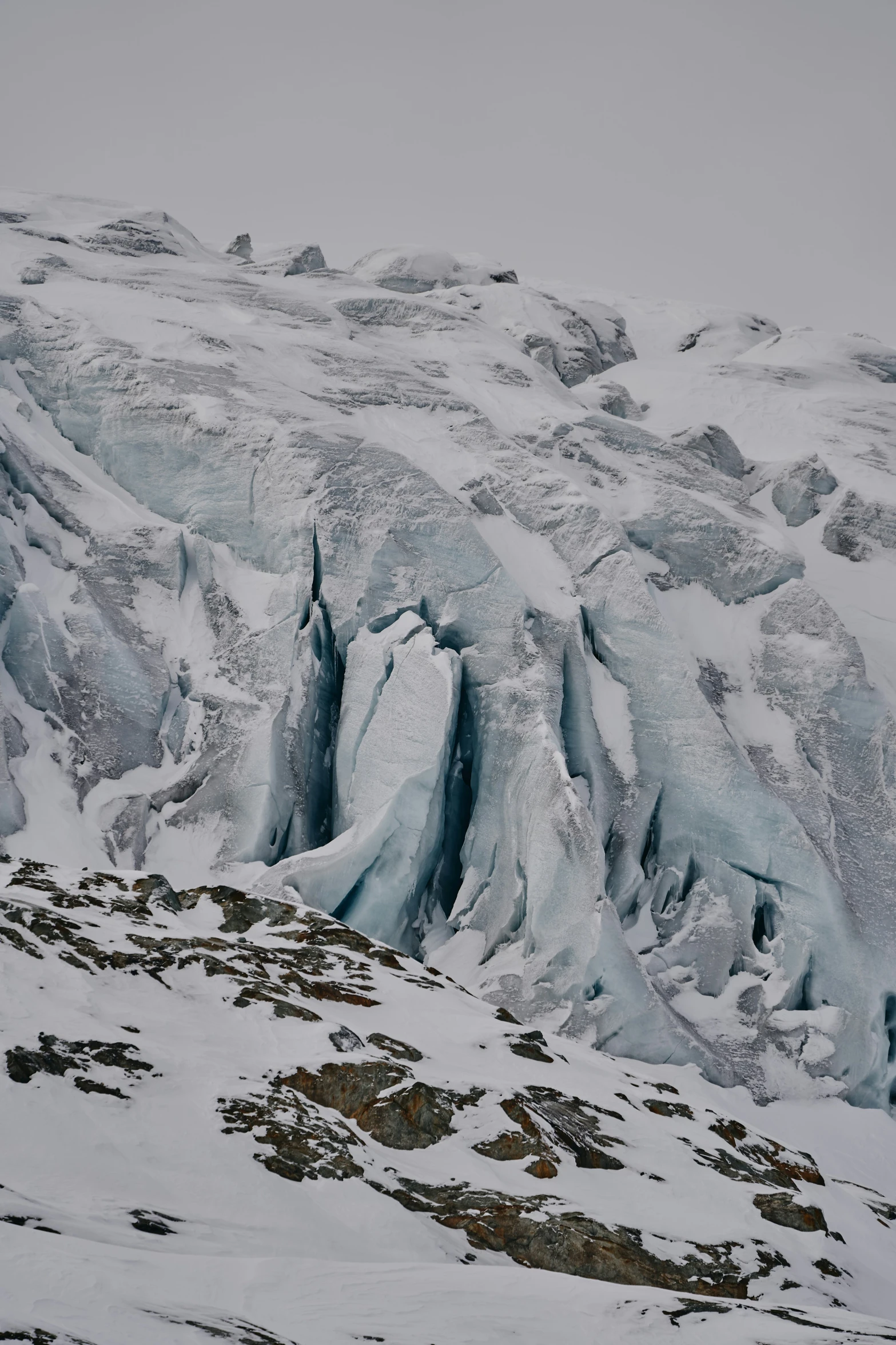 a couple of mountains covered in snow and rocks