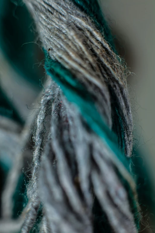 yarn is hanging from the ends of a large ball of string