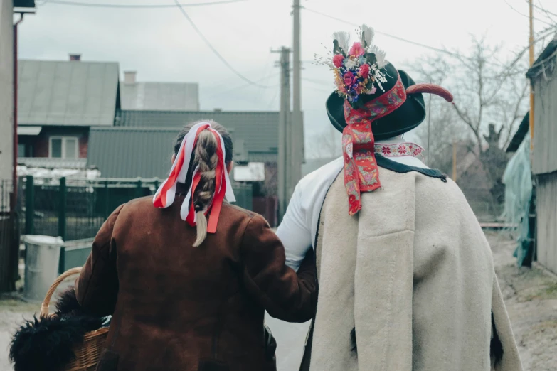 two people in costume walking together on the street