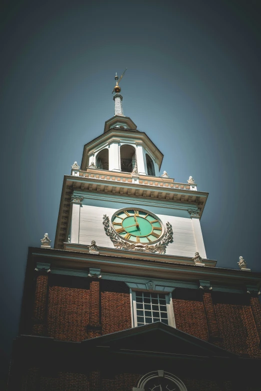 a large clock on top of a building under a blue sky