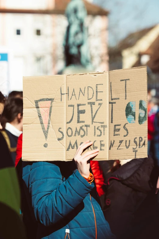 a protestors holding up placards with writing on them