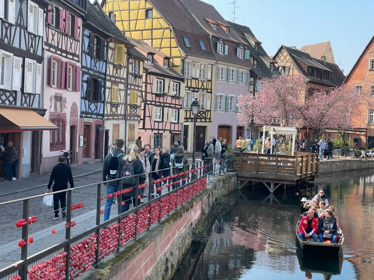 people on boats traveling along a river in the city