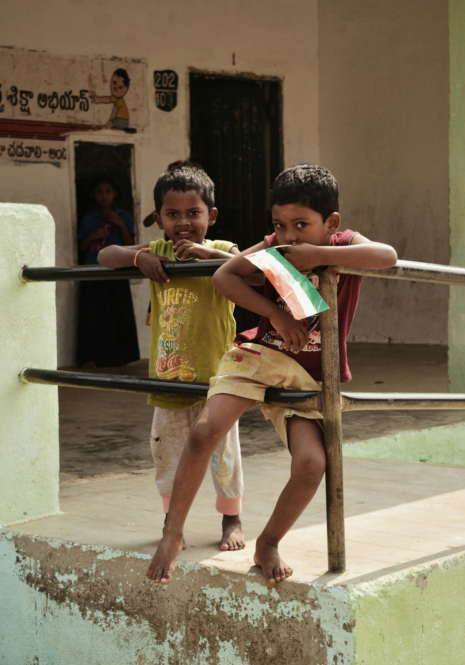 two small children standing on some steps