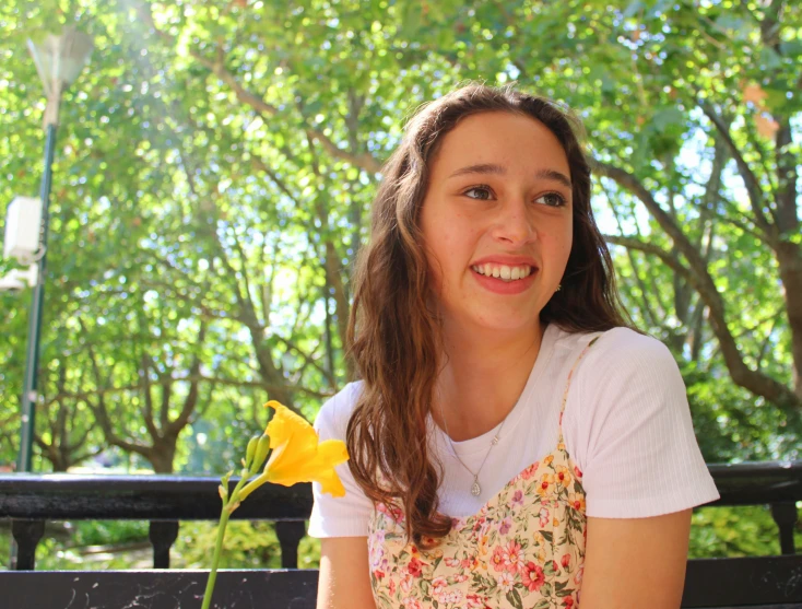 the woman smiles while looking at her camera