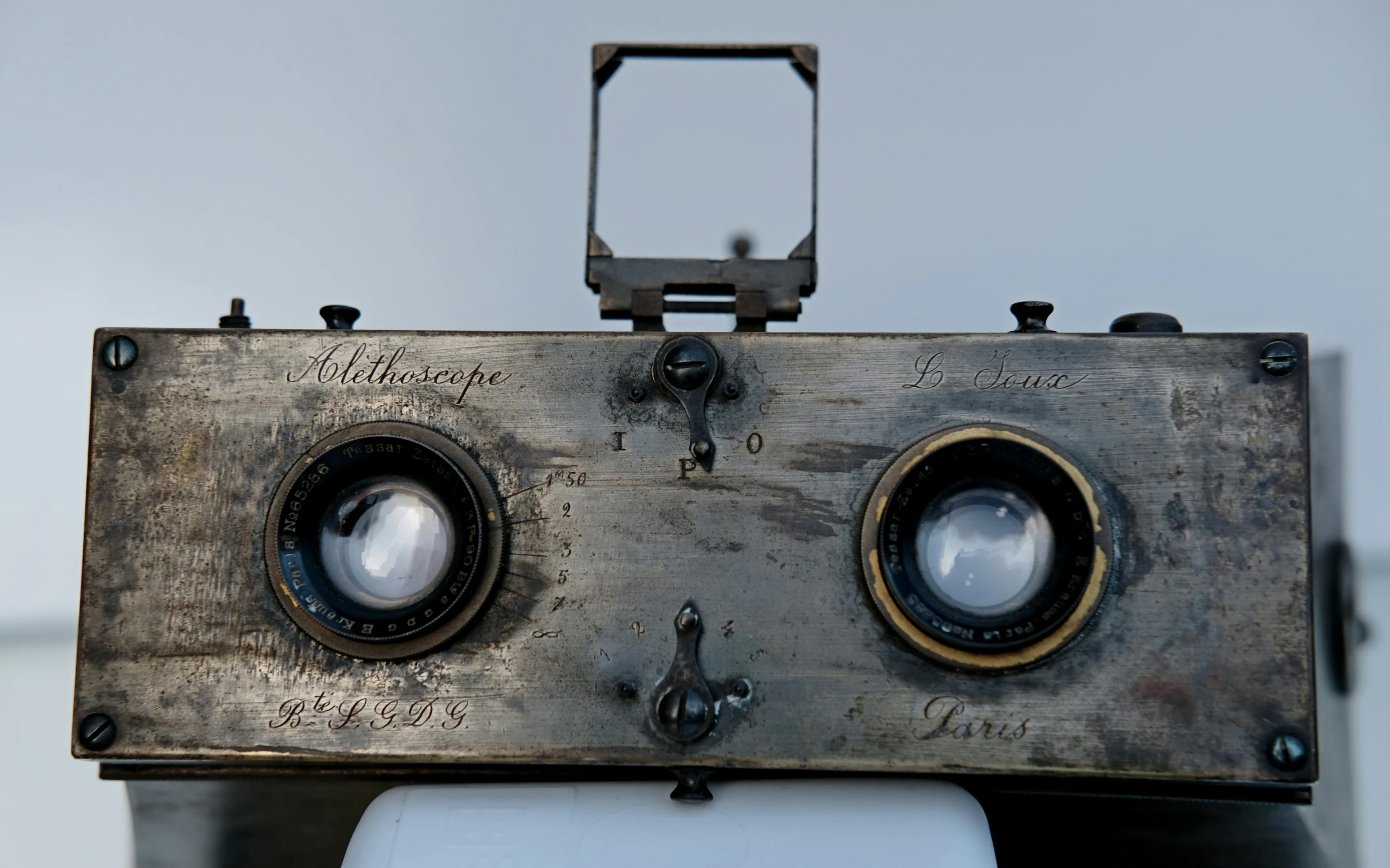 a close up of two cameras sitting on top of a table