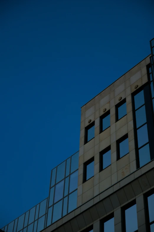 the back of a building with a clock and some windows