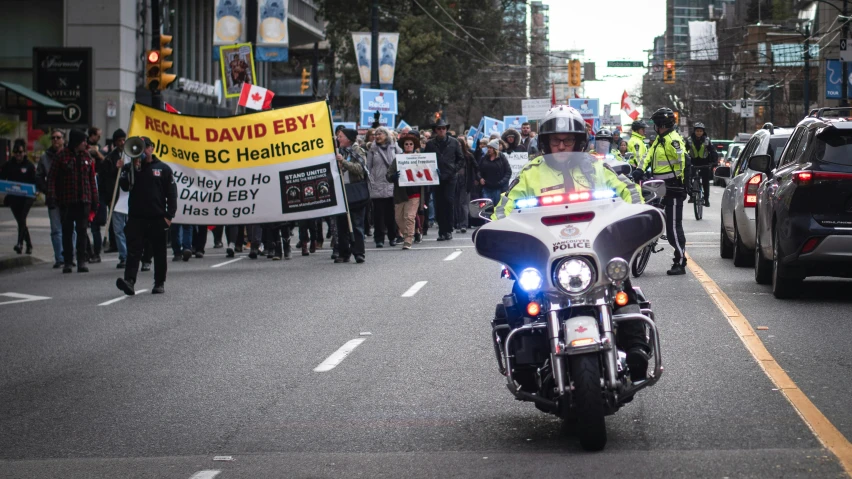 a police officer on his motorcycle driving through the city