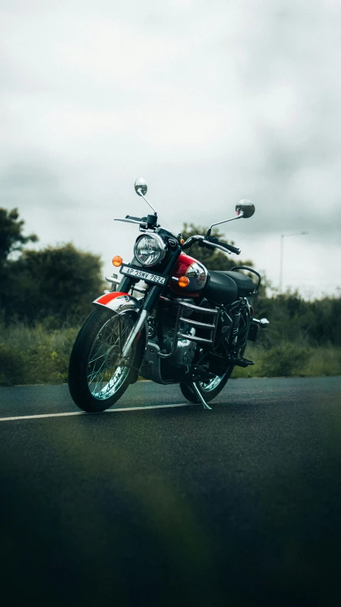 a black motorcycle is driving on a road