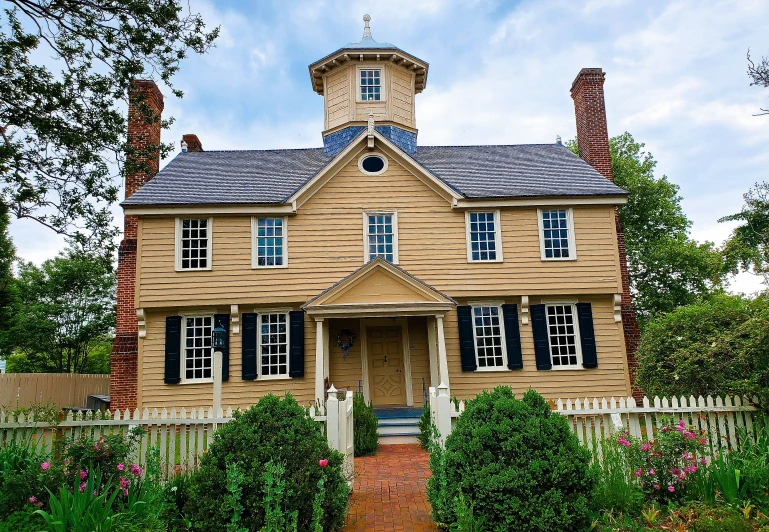 a beautiful old house has blue shutters on it