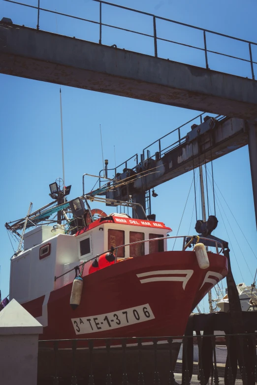 an image of a boat that is under a bridge