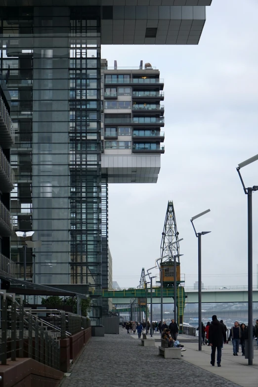 a building next to some people walking on a sidewalk