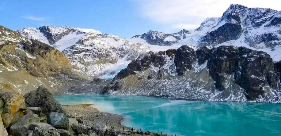 two mountain peaks with green water in them