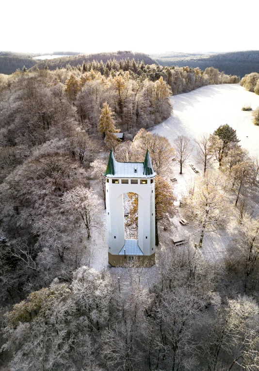 the top of a large building on a hill next to a river