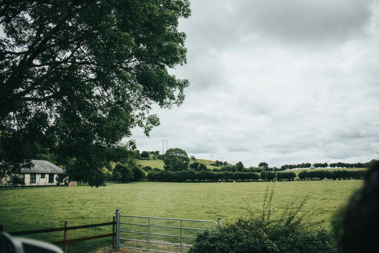 a field is seen through a wire fence