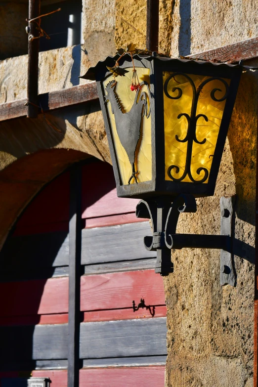 a yellow street lamp is hanging from a building