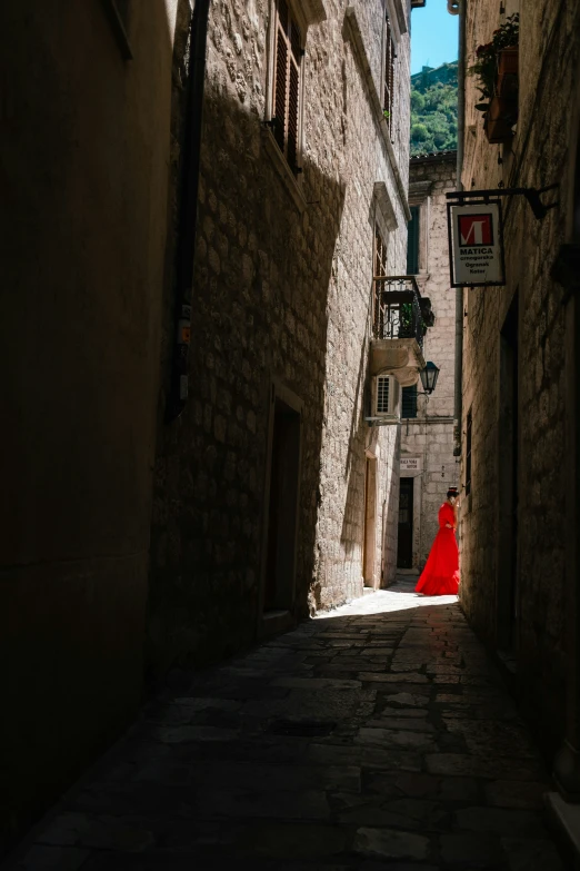 a dark street with a red cloak on it