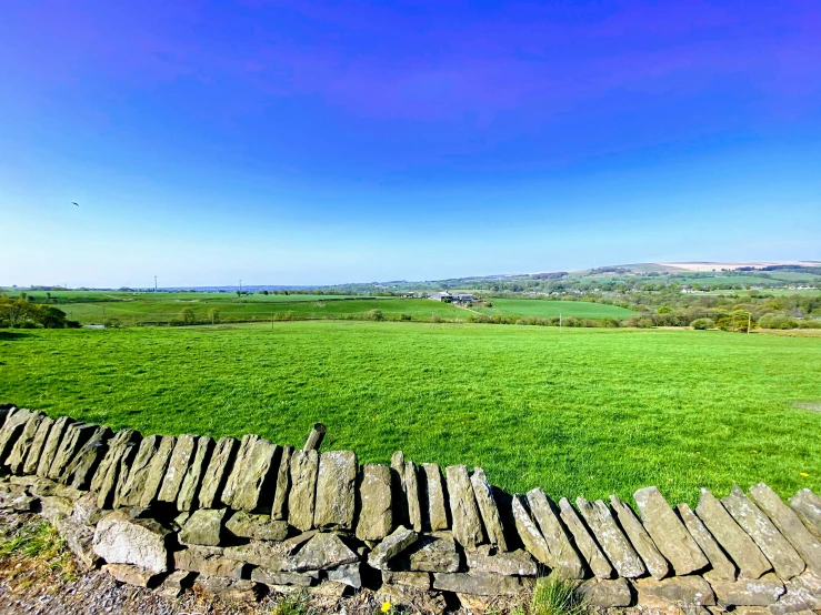 an outdoor s of a stone wall and a field