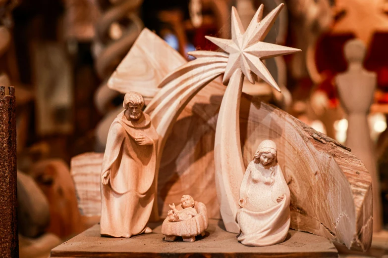 a nativity scene of wooden figures, figurines and a star