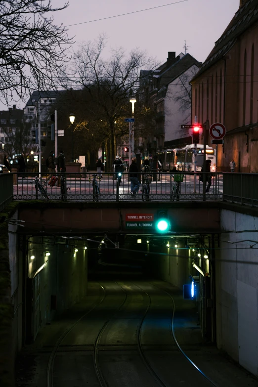 a light under a bridge in the middle of town