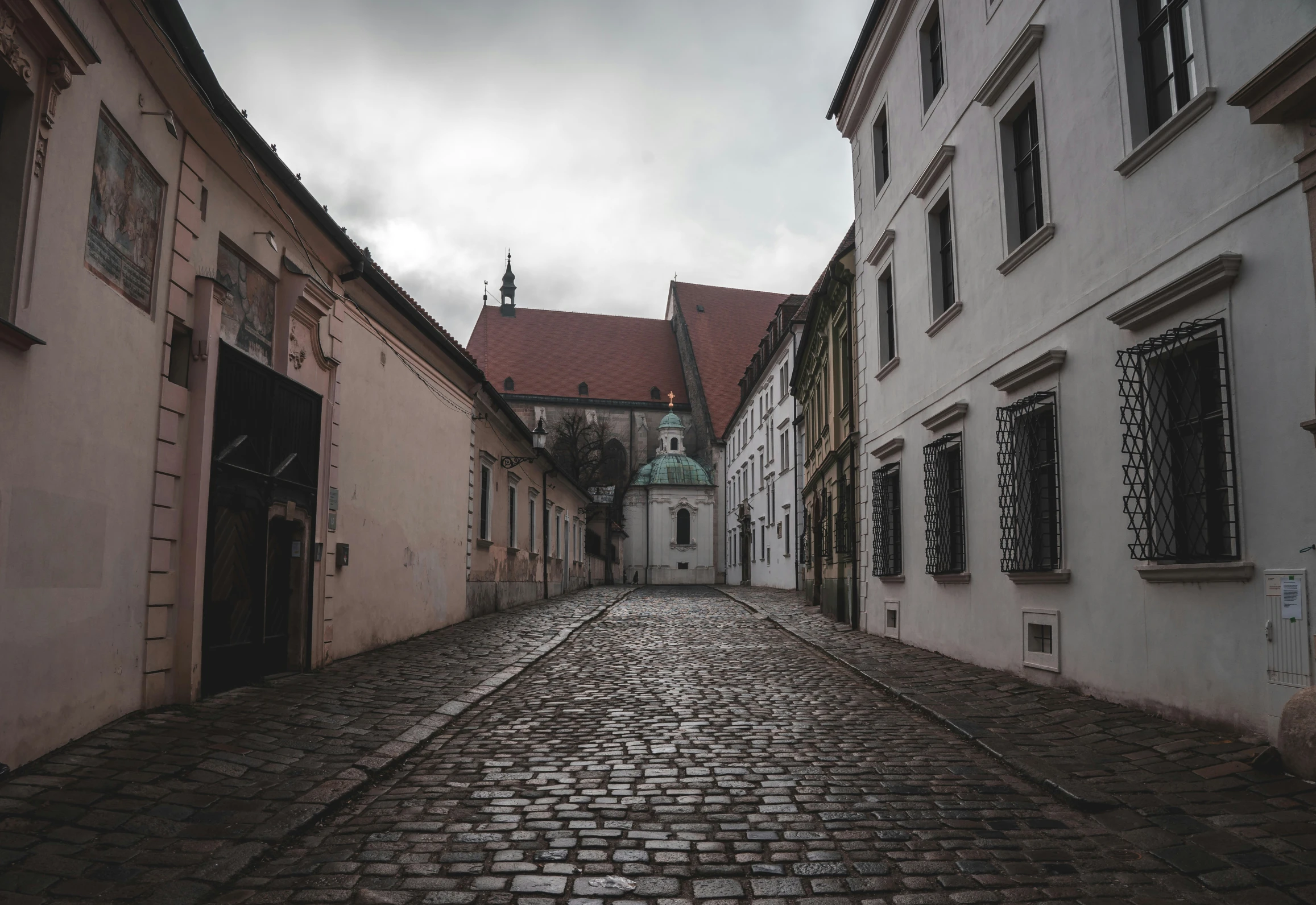 a cobblestone street with buildings and windows