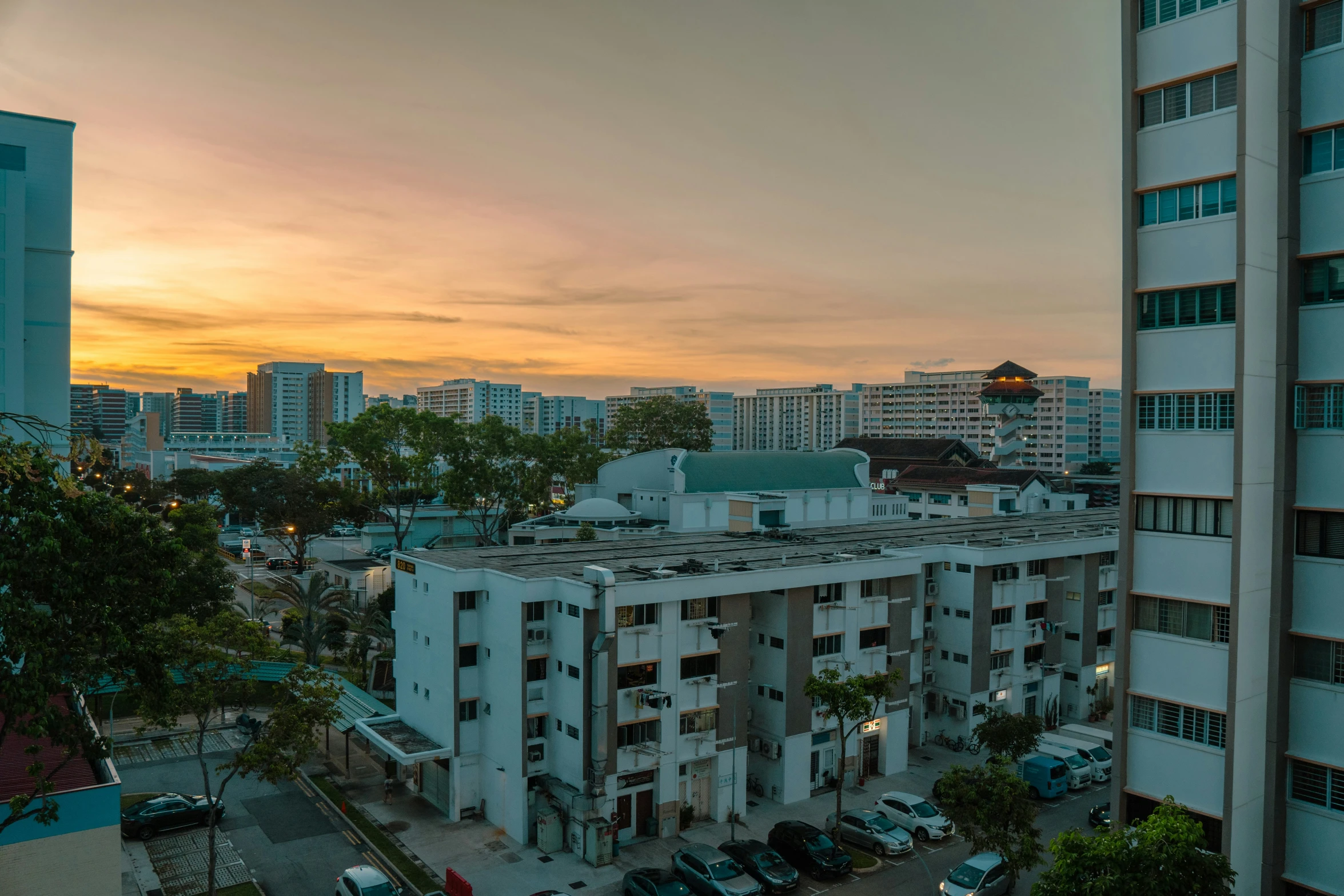 an overview of buildings in the city at sunset