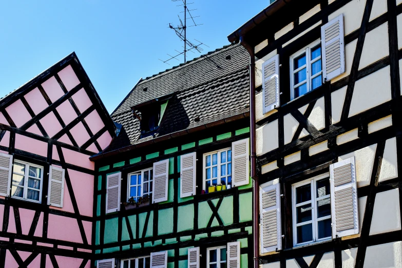 old buildings with windows and shutters in different colors