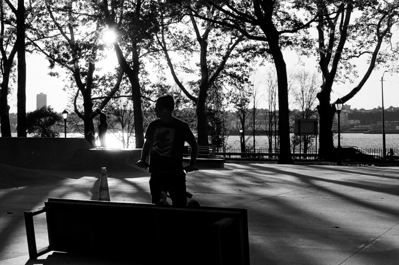 a person is walking through a park while looking out at trees