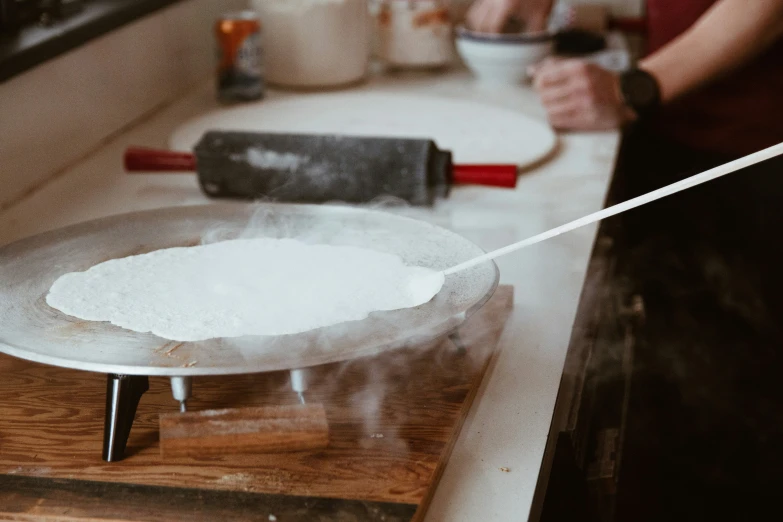 a person is making soing on a kitchen counter