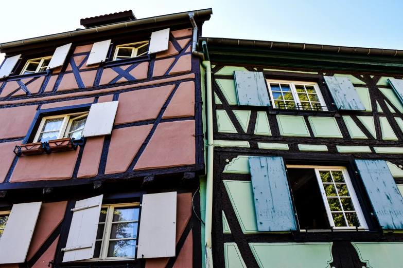 a building with windows that have a blue sky in the background