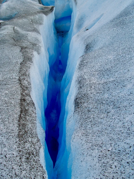 a deep hole that is in the ground covered in snow