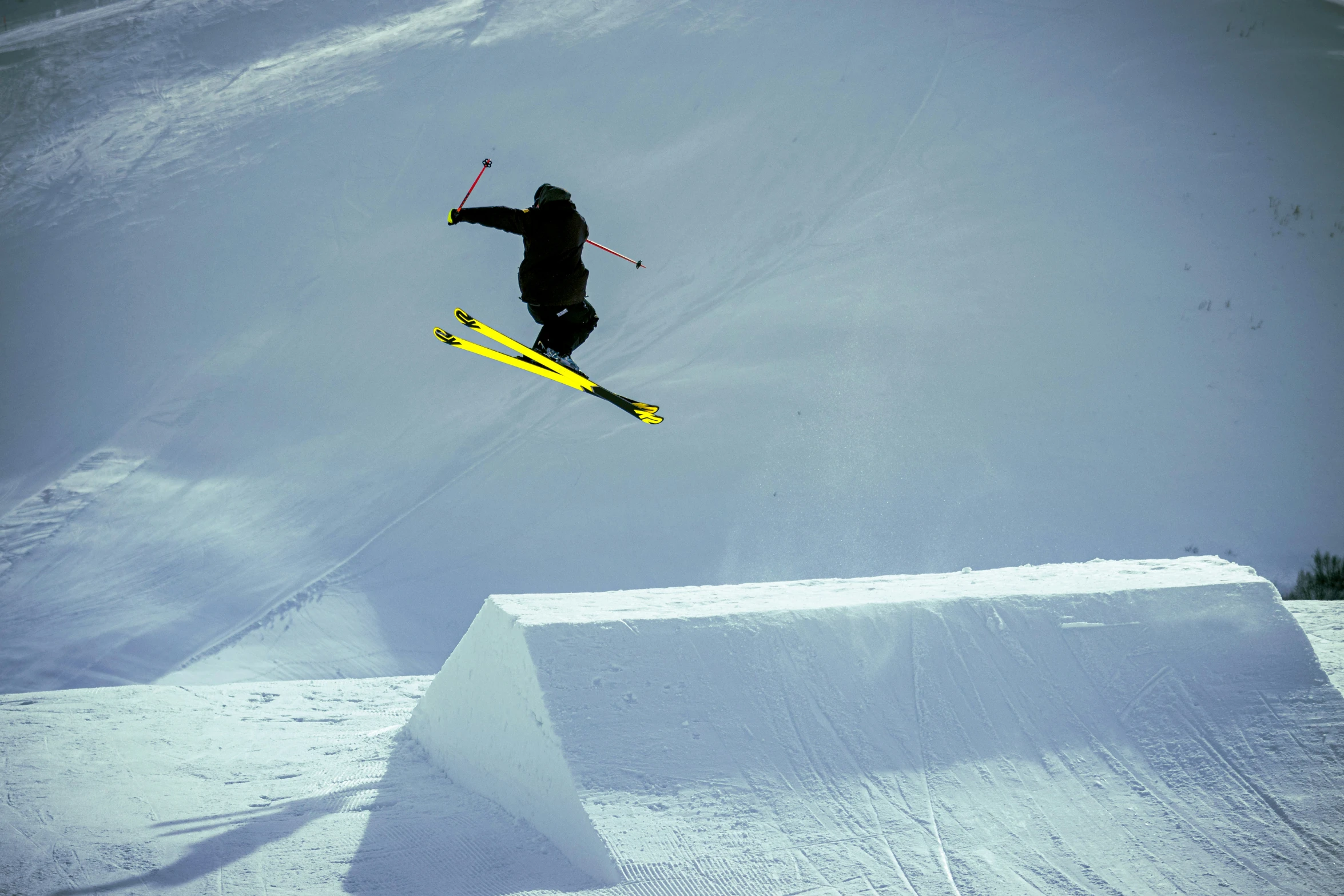 a man flying through the air while riding skis