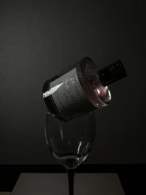 a half empty wine bottle and its spout