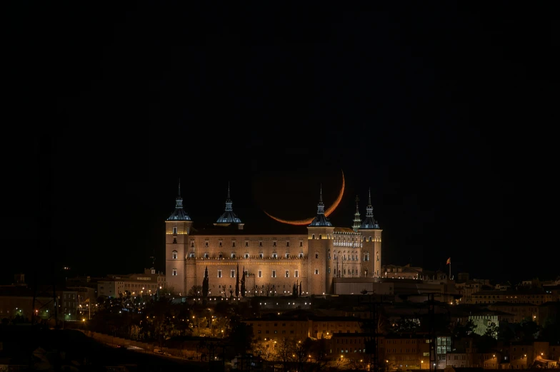 a large building with towers in the dark sky