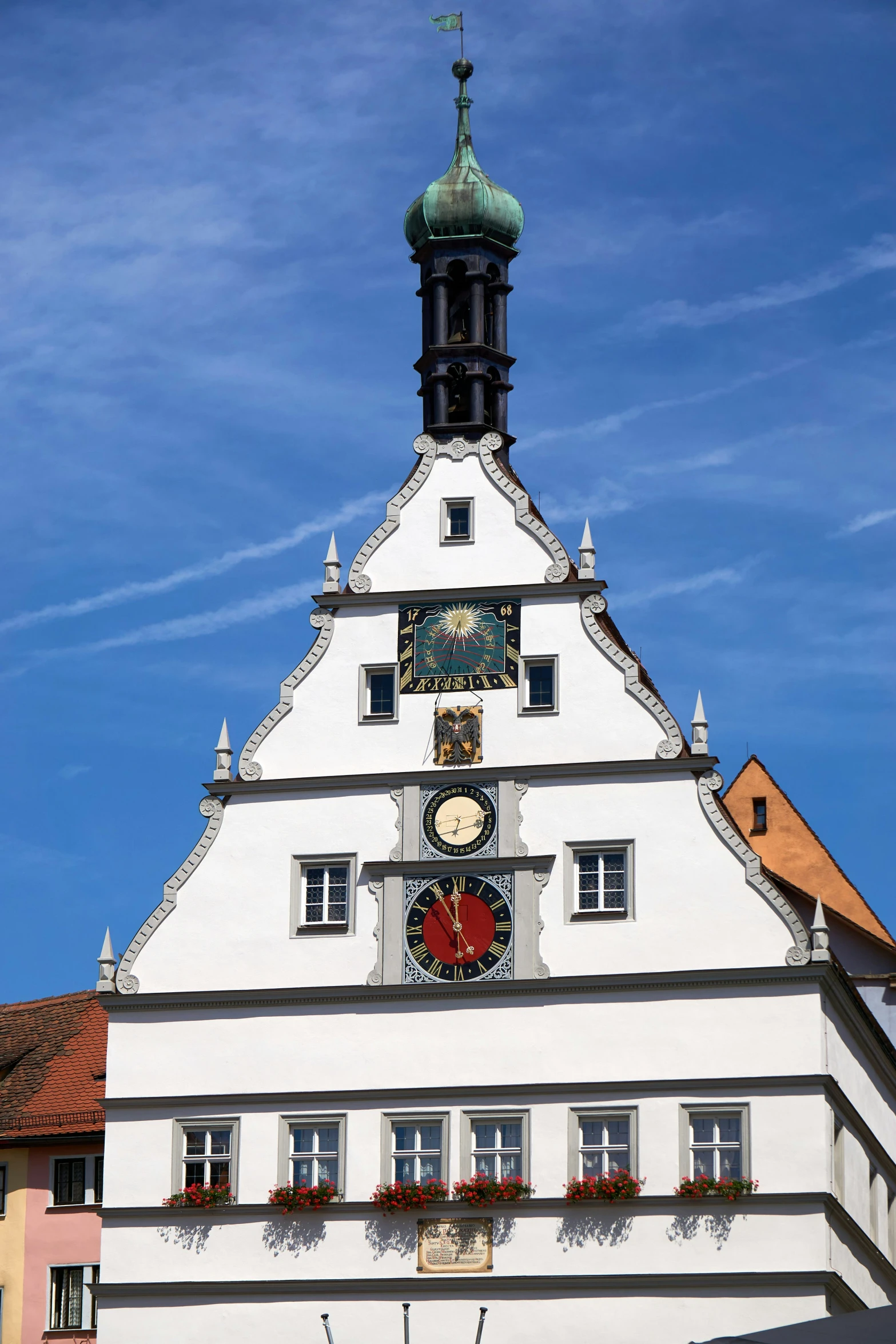 a very tall white building with a clock tower on the top