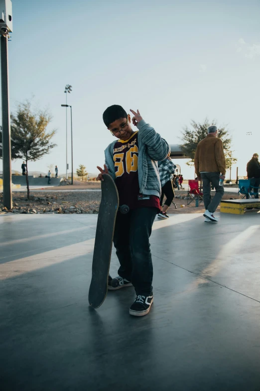 a young man standing on a skateboard in a skate park