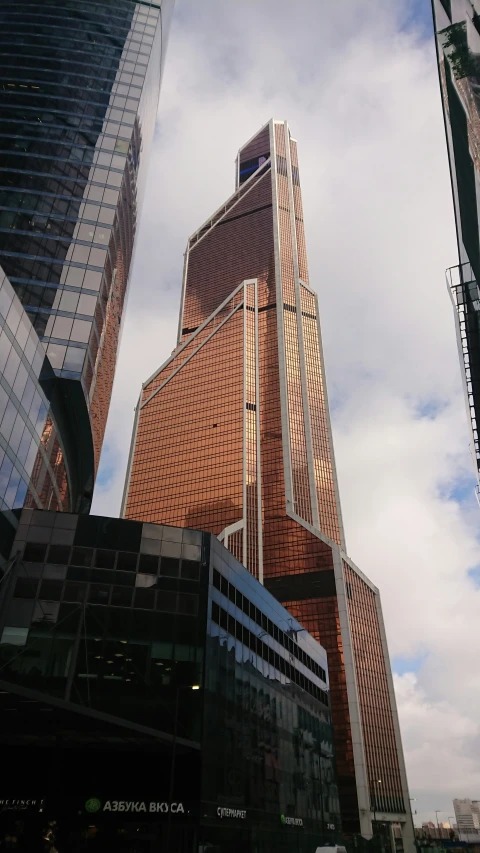 the tall brown building next to another tall one