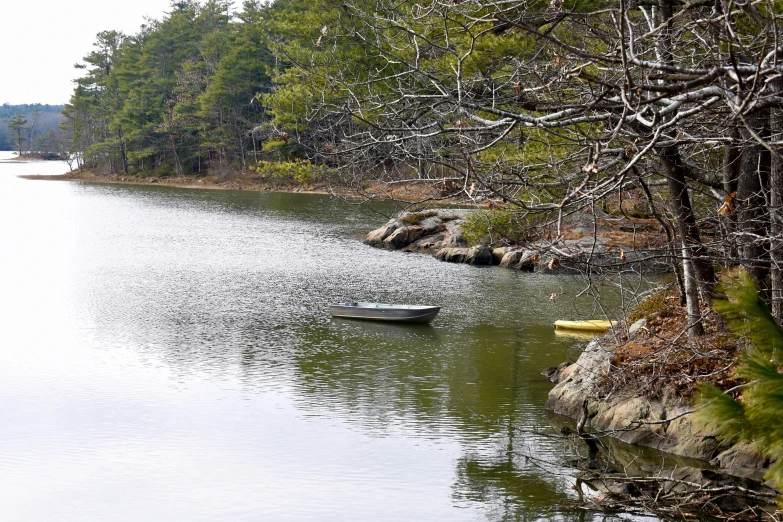 small rowboat floating on a calm, peaceful lake